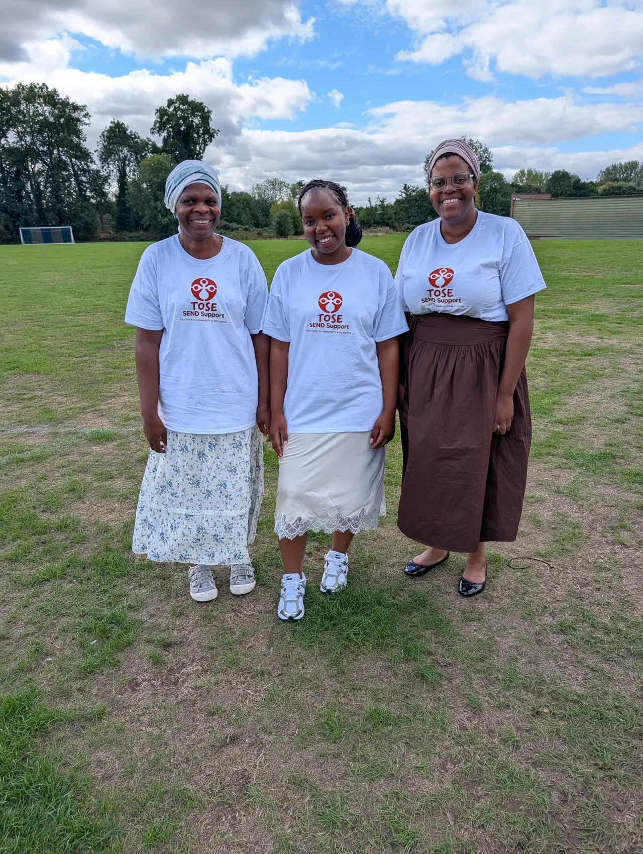 Three TOSE SEND Support members wearing TOSE T-shirts outdoors